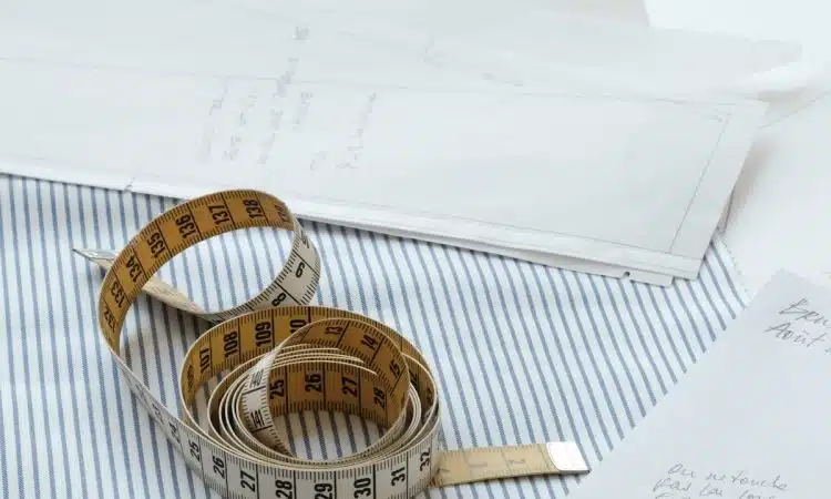 gold and silver bracelet on white paper