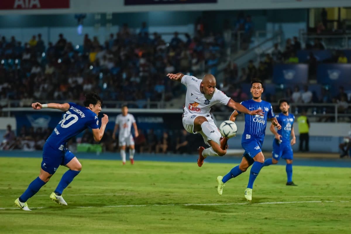 2 men in blue and white jersey shirt playing soccer